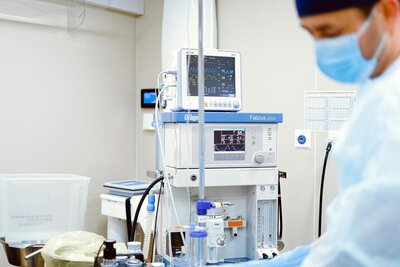 surgeon with monitor in background