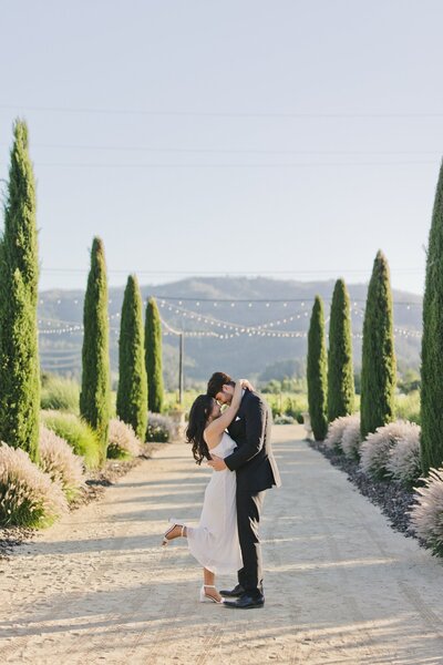 A wholesome wedding photo of a bride and groom sharing a loving embrace at their scenic Napa Valley Estate wedding.