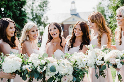 bridesmaids lauching looking at eachother