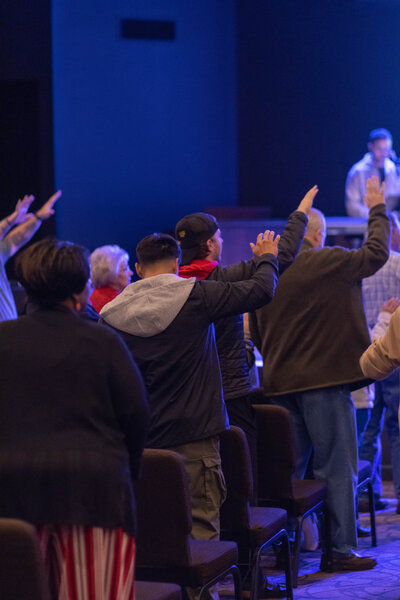 A multicultural group of people praying together at a non-denominational church in Fayetteville, NC. 