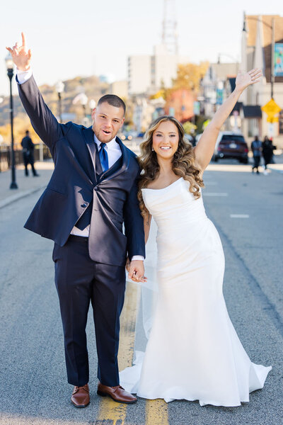 Photo of bride and groom walking the streets of Pittsburgh taken by Pittsburgh Wedding Photographer, Sara Haines