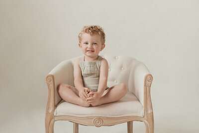Toddler smiling in studio by a Traverse City photographer

