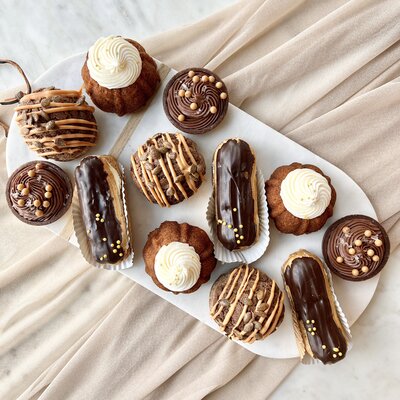 Vanilla almond sugar cookies in the shape of fall leaves on a plate.