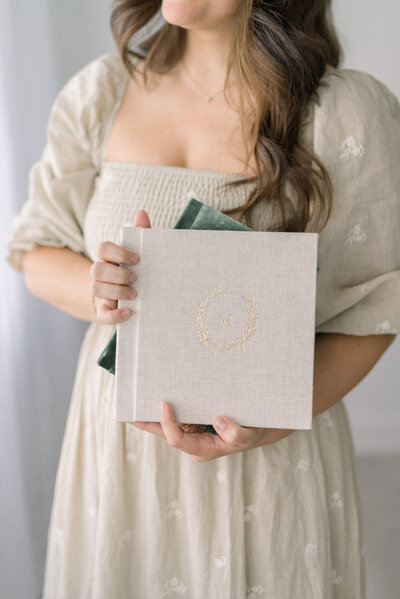 women holding fine art albums knoxville tennessee newborn photographer