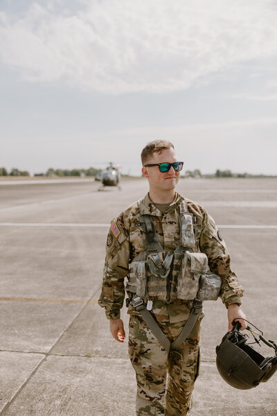 Soldier walking on a tarmac.