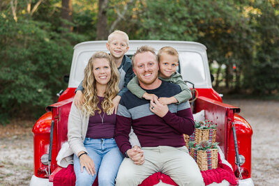 mom holding her baby bump at the beach