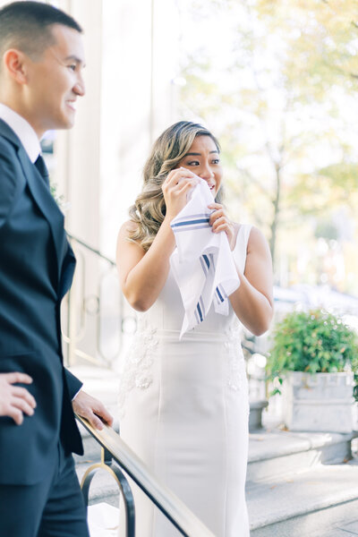 Bride wiping tears after first look with groom at The Willard, DC.