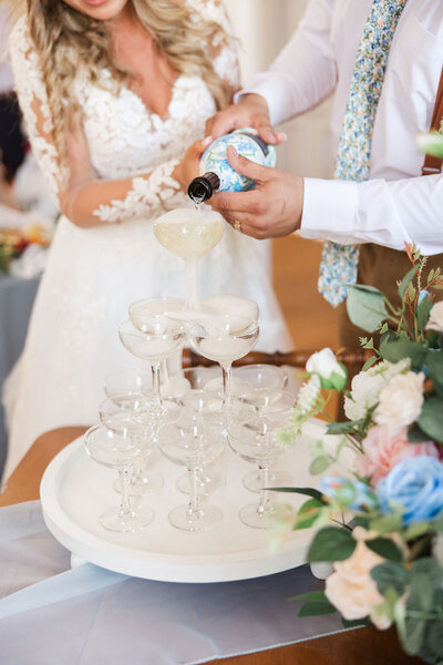 Photo of bride and groom pouring champagne.
