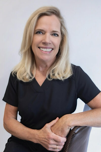 Photo of Amy Trupiano, RN, Registered Nurse at Refined Medical NY in East Setauket Long Island, assisting in patient care and IV therapy.