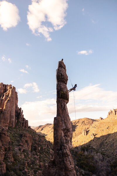bride and groom climbing totem pole