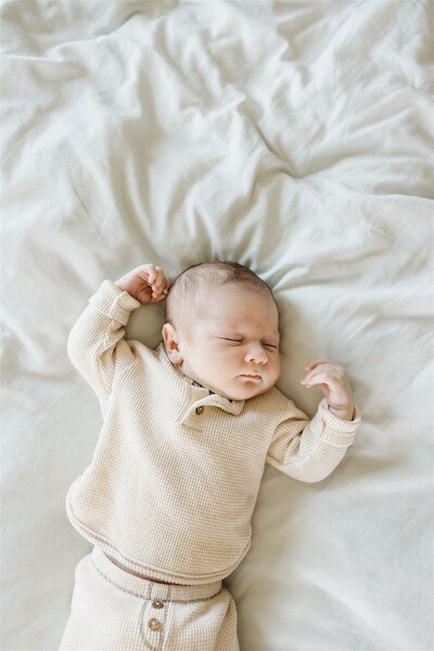 baby laying on a bed sleeping