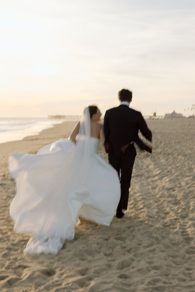 Beach Elopement Photos, couple running on the beach by southern California elopement photographer