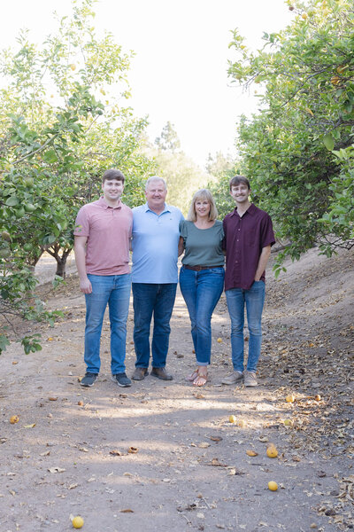 Family of four standing in a dry creek bed in Rancho Mission Viejo