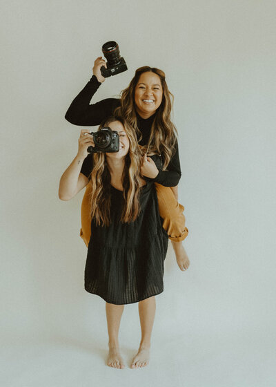 two photographers smiling at the camera