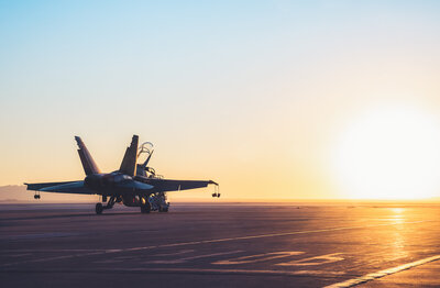 Plane taking off towards the sunset