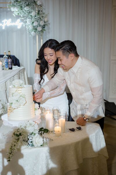 Bride and groom cutting the cake