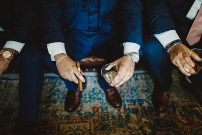 Groom holding cigar and drink