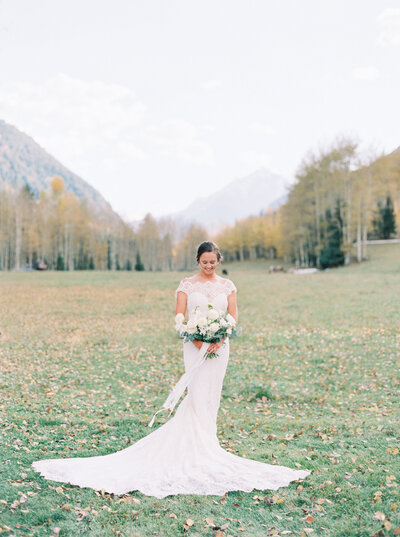 Bride in front of Maroon Bells mountain fall leaves field Denver Wedding Photographer
