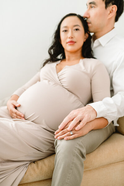 couple poses for their maternity session in seattle