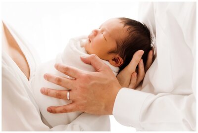 newborn baby with parents hands by newborn photography boston ma​
