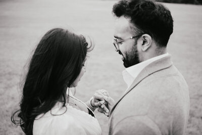 Engaged couple admiring engagement ring