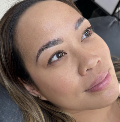 A close-up photo of a client's eyebrows before and after undergoing our professional brow shaping and tinting services at Wilde Beauty Co. in San Diego, showcasing the dramatic transformation and natural-looking results that our expert technicians can achieve.