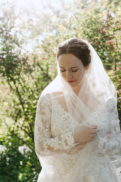 Bride poses with her veil outside of Notre Dame Basilica Church, Ottawa for her solo portrait