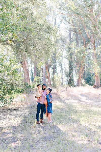 family of 3 posing at a park in orinda california for their san francisco bay area family session, photo by Anastasiya Photography - San Francisco Wedding Photographer
