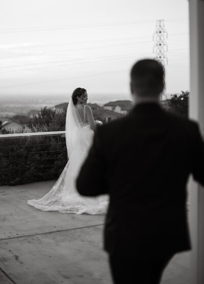 Wedding Photographer, Groom sees his bride as he walks up behind her outside