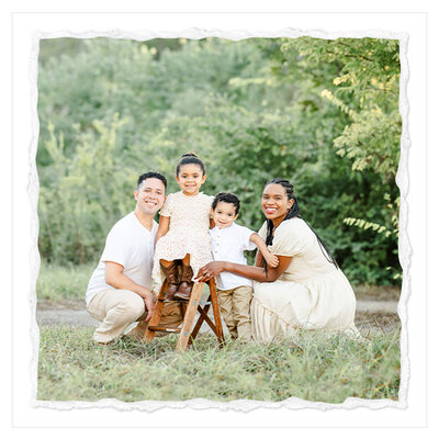 The picture captures a heartwarming family moment in a serene, natural setting. The family of four - mom, dad, son, and daughter - are standing in a lush, green field with a backdrop of a forest at sunset. The warm, golden hues of the setting sun cast a soft, ethereal glow over the scene.  The parents are squatting down, holding their children close. The son and daughter are smiling brightly at the camera, their expressions radiating joy and happiness. The family's body language suggests a close, affectionate bond, with the parents' arms wrapped around their children in a protective and loving embrace.  The overall composition of the image is light and airy, with the natural surroundings providing a beautiful, serene setting for the family portrait. The photographer, Bri Sullivan, has captured the moment with a skilled and artistic touch, using the natural lighting and the family's relaxed, genuine expressions to create a truly stunning and memorable image.  The picture is a testament to the beauty and simplicity of family life, and the joy that can be found in spending quality time together in nature. It's a heartwarming and uplifting image that is sure to bring a smile to the viewer's face.