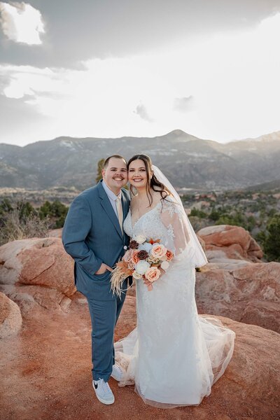 Colorado elopement photography of a bride and groom with flowers and garden of the gods location