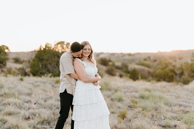 man holding woman hugging her