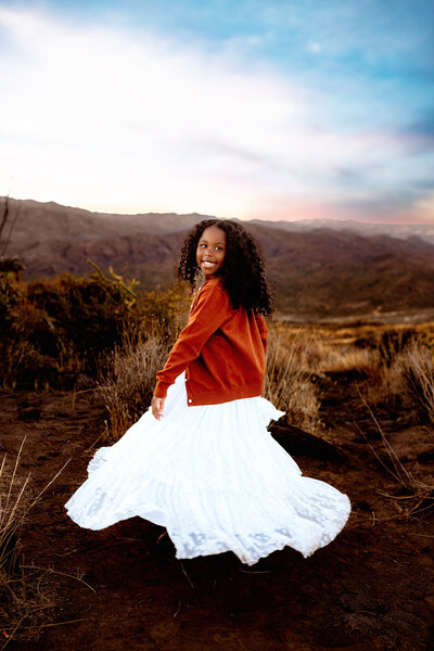 Family session in Scottsdale desert with happy child in white dress