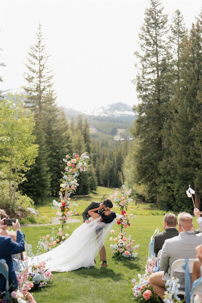 Colorado mountain wedding with bride and groom embracing in wildflower field