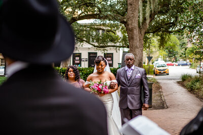 A stylish Black couple exchanges rings during their intimate micro wedding ceremony, officiated by Atosha Barboza-Bennett of Larger Than Life Events & Behind the Veil Academy. A perfect union captured beautifully.