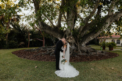 bride and groom share a kiss on wedding day