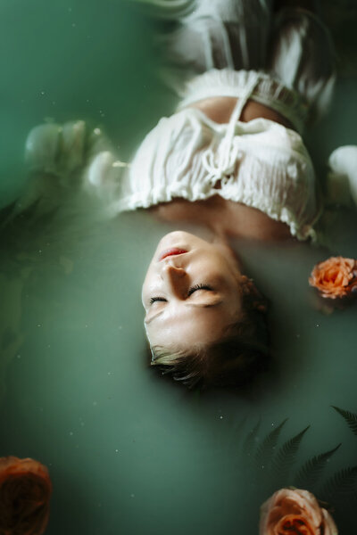 senior session in the water with flowers