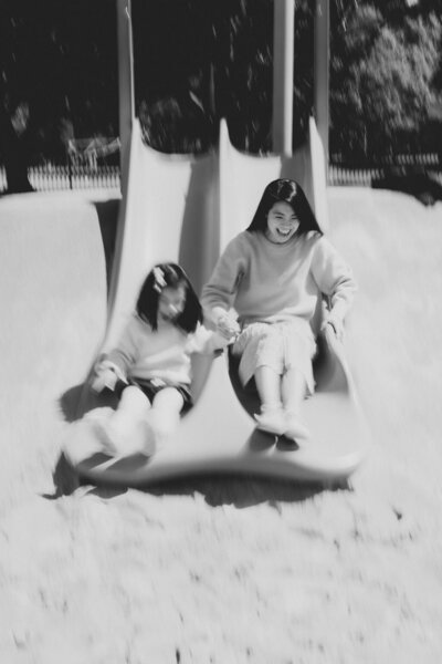 Mum playing with toddler in the playground at a park