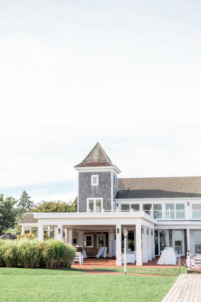 The iconic shingle-style architecture and waterfront setting of Wychmere Beach Club in Cape Cod. A dream wedding venue for couples looking for seaside elegance and breathtaking backdrops