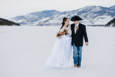 Bride and groom hold hands in Sapphire Point Overlook micro wedding photo.