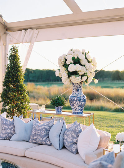 Close up of the plush sofa and flower arrangement. 