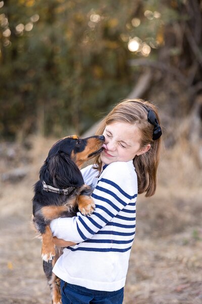 girl holding weenie dog