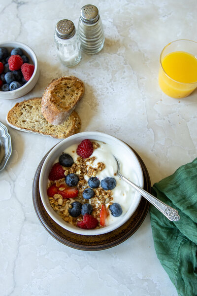 Yogurt parfait with berries and granola, toast and orange juice.