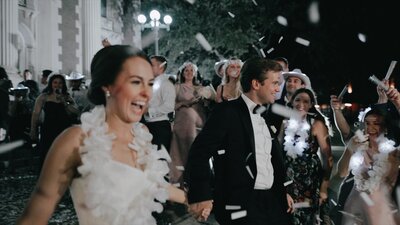 A Texas wedding videographer captures the joyful moment of a bride and groom amidst confetti celebration.