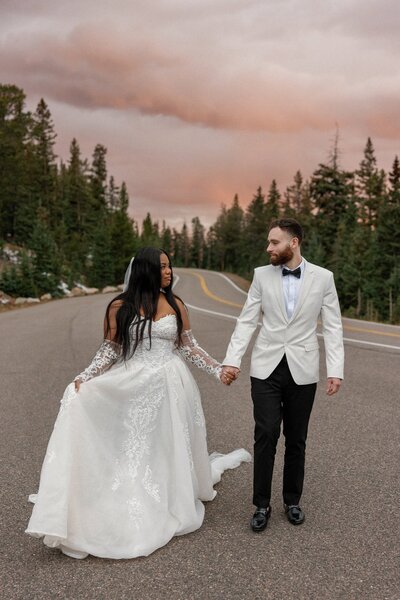 Bride and groom walk hand-in-hand during Colorado elopement.