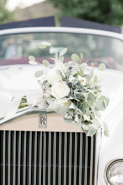 white floral bouquet sitting on top of car