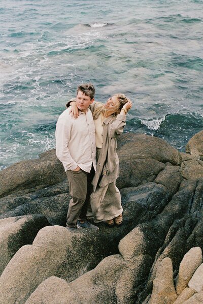 A couple at the beach in Greece looking out into the distance as a Tampa, FL photographer captures the moment.