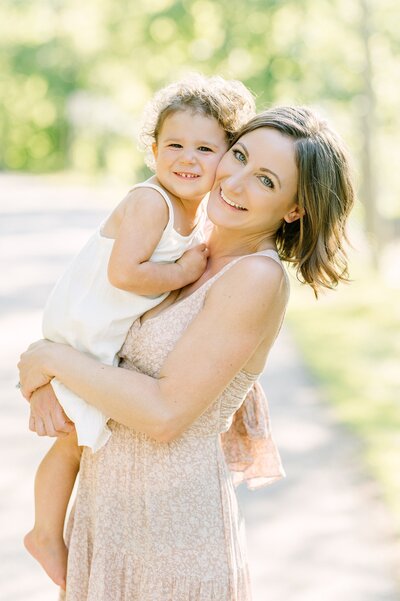 Mom and daughter smiling at camera at Milwaukee portrait session