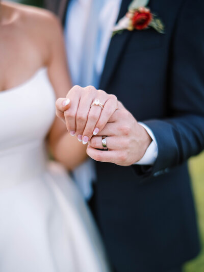 a bride and groom in blue with wine glasses clinked together by Colorado Wedding Photographer JKG Photography