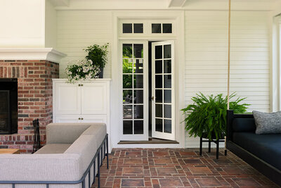 Traditional exterior spaces of a historic Boston estate updated with modern furniture by a Boston interior decorator, blending classic and contemporary.